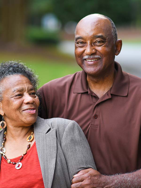 Portrait of African-American Couple Smiling at the Camera with a blurred Nature Background at Scout Advocacy