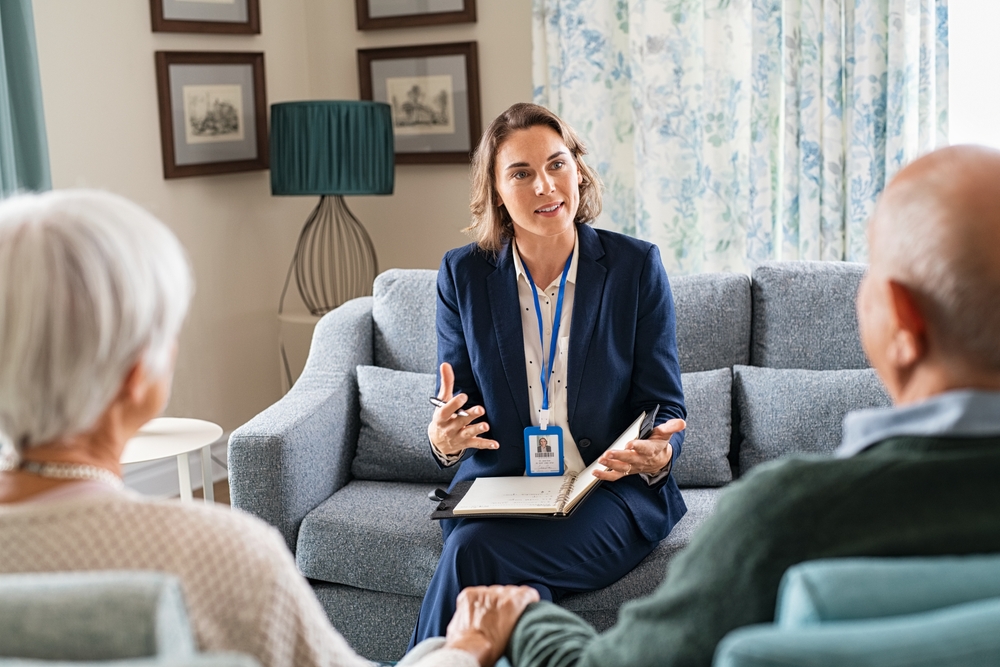 Social worker talking to old man and woman